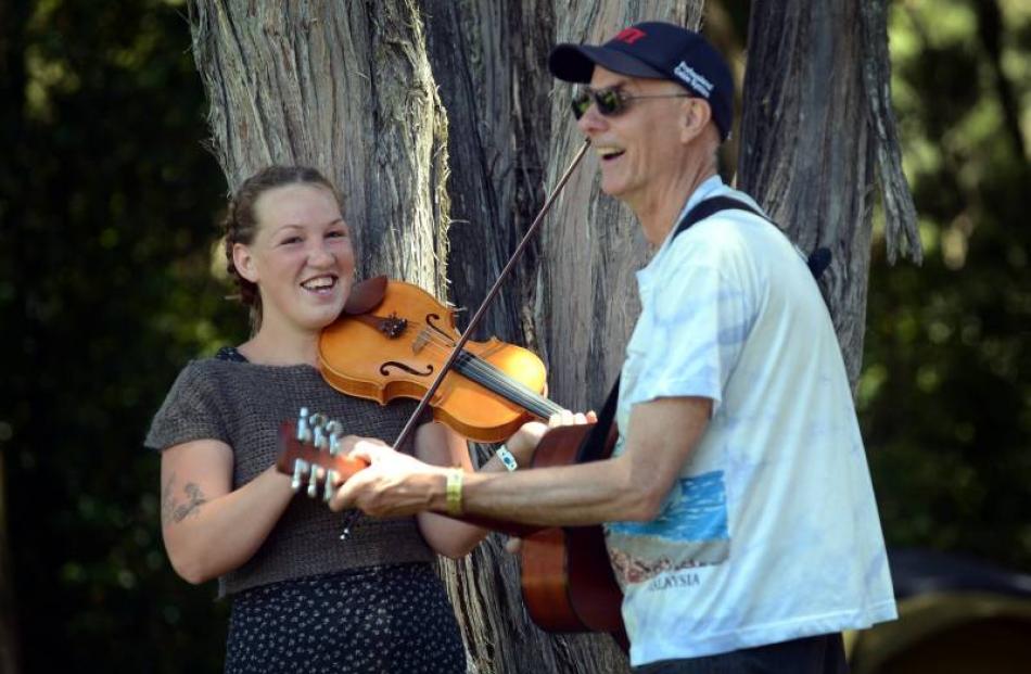 Fine tuning their instruments are Dunedin musicians Flora Knight and John Dodd