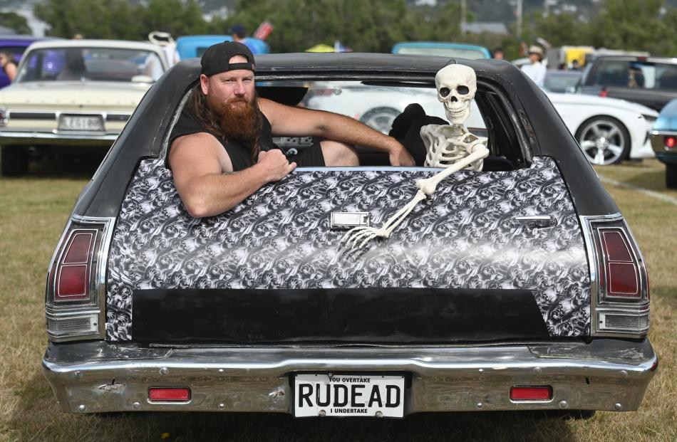 Axl Tilden has company in his Halloween-themed hearse — a 1975 Plymouth Fury — at the 35th Great...