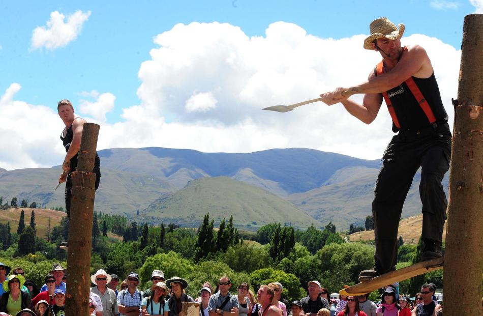 Troy Kirkby, left and Ben James compete in the axe challenge during the Kiwi Lumberjacks show at...