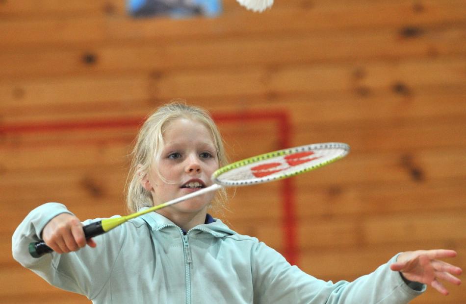 Kaikorai Primary School pupil Genevieve Hodgson, 9, aims for the shuttlecock in badminton.