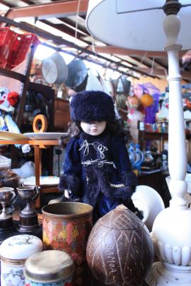 A doll stands among an assortment of  items  in the Shingle Creek Collectables store.