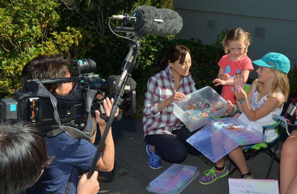 Japanese television presenter Kei Otozuki chats to Baldwin St residents Laura(3) and Meila...