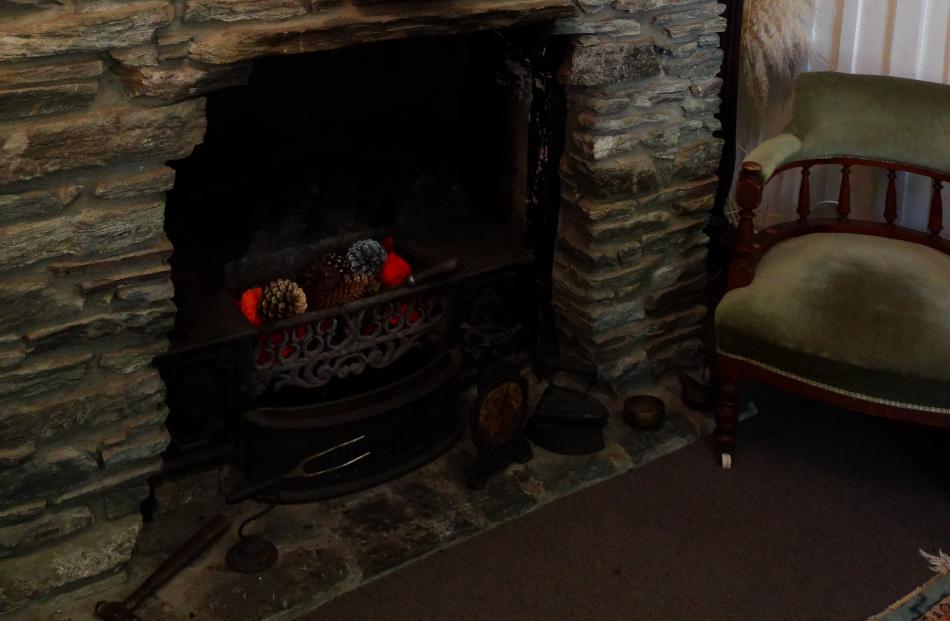 Historical elements are displayed in front of the original fireplace in Stevenson's Cottage.