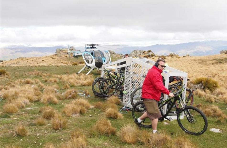 Peter Donaldson wheels his bike from the transport cage.