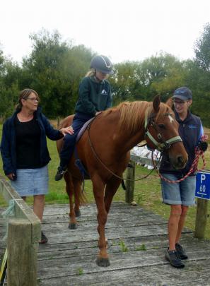 Heading over a bridge are (from left) Highfield Primary School teacher aide Erin Miller, pupil...