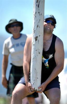 Matthew Foster tosses a 25kg caber  during the Caledonian Society of Otago's inaugural Highland...