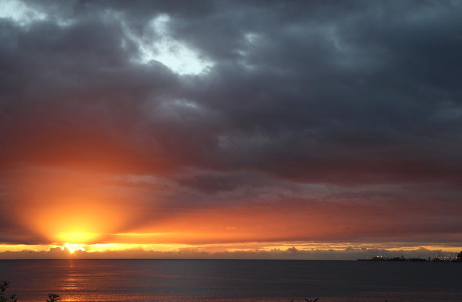 A spectacular Hawkes Bay sunrise out-shines the Port of Napier lights.
