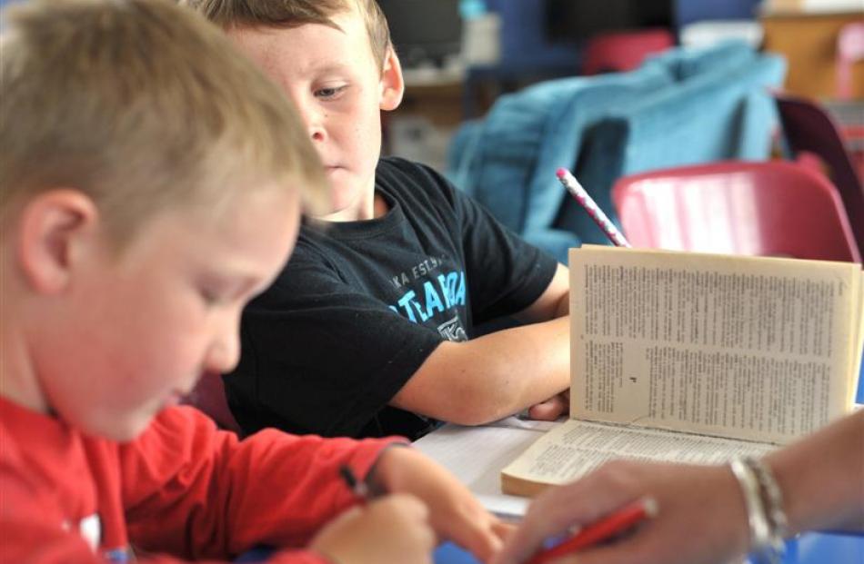 Liam Lash (left) and Liam Patterson look up the meaning of ''integrity'' in their dictionaries.