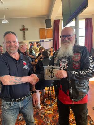 Evan Jenkins, Milton Bruce RSA President, accepts a donation from Phil Herriott, Patriots Deep...