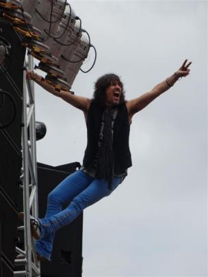 Foreigner vocalist Kelly Hansen gets hearts racing by climbing high up the stage scaffolding...