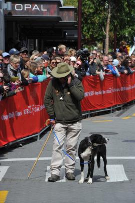 John Harvey, and his dog Bob, from Martinborough, await the mob on Beach St.