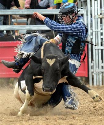 Cowboy Ben Forsyth competes in the second-division bull ride.