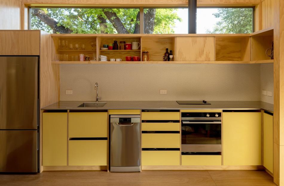 Pops of yellow add visual warmth and contrast with the mainly timber surrounds.