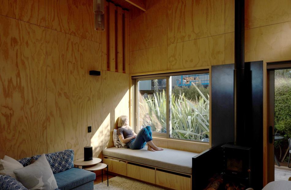 Leafy views are offered by the window seat alongside the wood-burner.