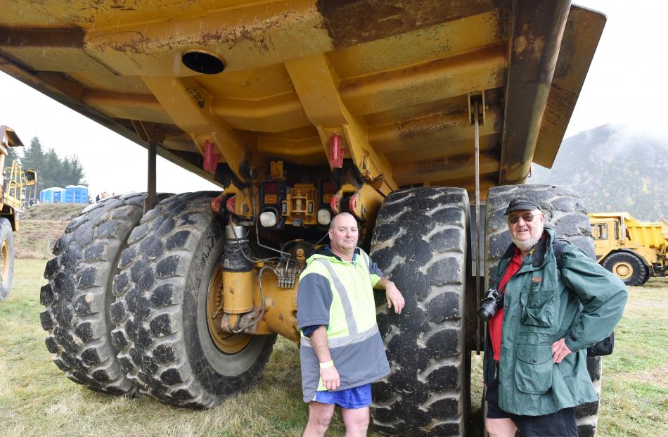 Brent (left) and Roy Robinson, father and son from Katikati, seek shelter from the rain under a...