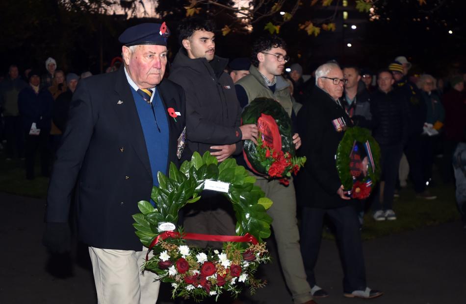 Lox Kellas, of Dunedin, leads the laying of wreaths.
