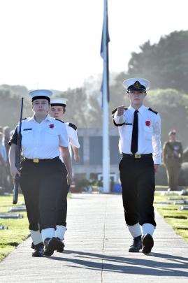 TS Neptune navy cadets (from left) Ash Prent, 17, Nicholas Reid, 16, and Mitchell Fox, 18, march...