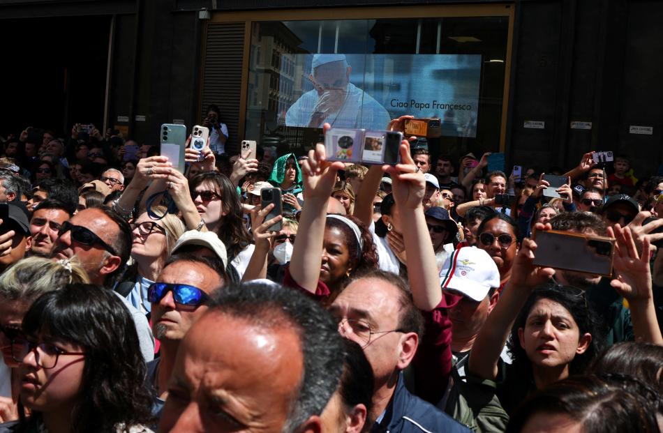 People watch as the coffin arrives at the Papal Basilica of Saint Mary Major. PHOTO: REUTERS