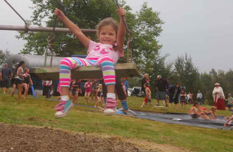 Ruby Morris (4), of Waikoikoi, has a go on the merry-go-round.