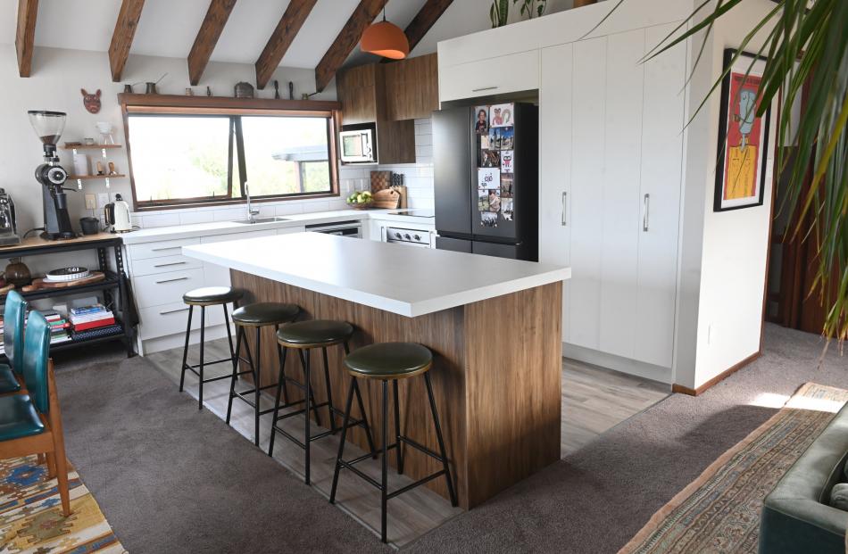 The previous owners installed the white-and-woodgrain kitchen.

