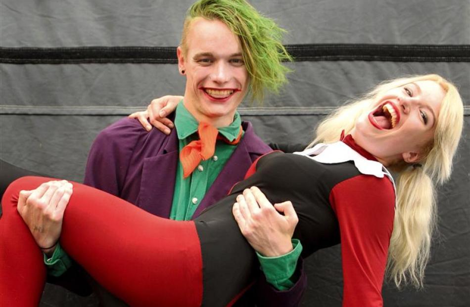 Samuel Rillstone, as The Joker, holds Victoria Ransom, as Harley Quinn.