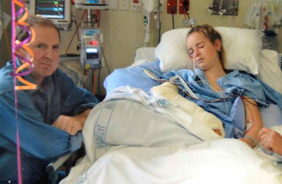 Olivia in Dunedin Hospital with her father, Bryan, at her bedside.