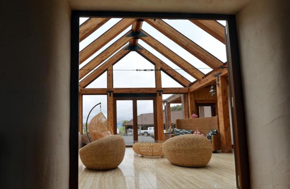 The conservatory's large windows and skylights draw heat into the building while the thick straw...