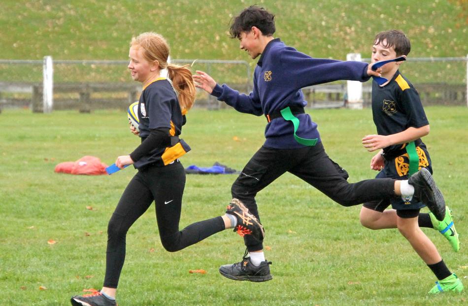 Tokomairiro School 11-year-olds Blake Eckhold (middle) and Hunter Wardell catch up with Haley...