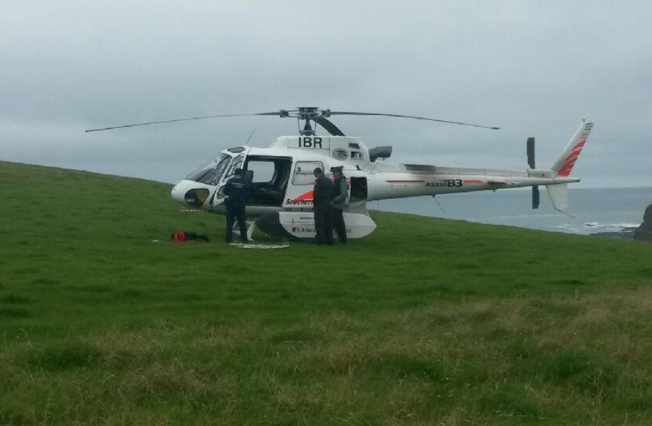 A helicopter prepares to search the bay. Photo by Hamish MacLean