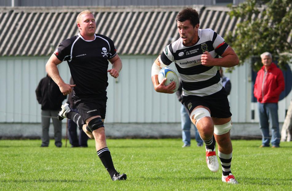 Southern flanker Adam Knight runs over the tryline to score...