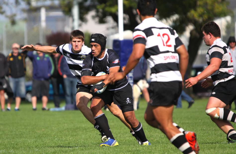 Pirates lock Motu Hutch attempts to break the tackle of...