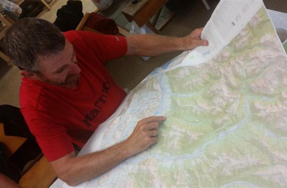 Studying a map of Arthurs Pass.