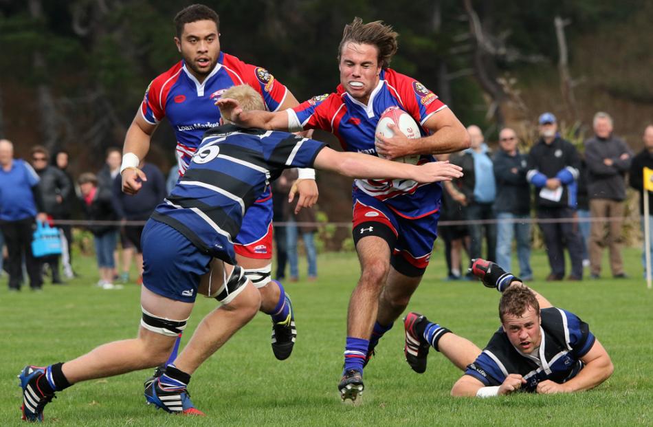 Harbour first five Joe Collins braces himself to be tackled by Kaikorai flanker Jared Goodson...