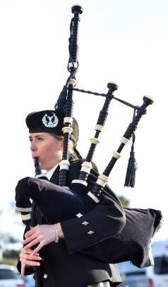 Otago Girls’ High School piper Sophie McLellan, 17, welcomes people who landed on the first...