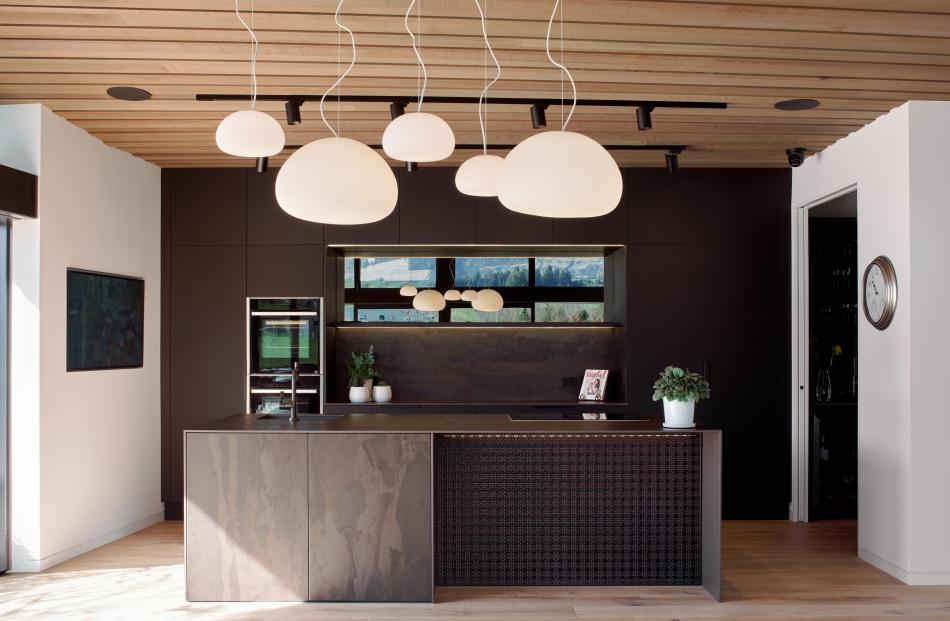An induction cook-top set into the kitchen island provides a sociable space for cooking.


