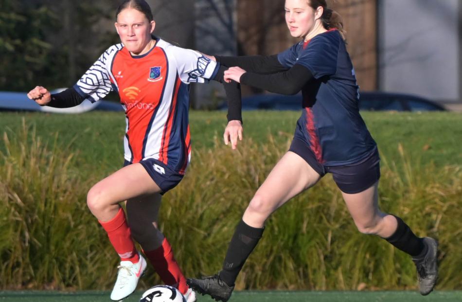 Jean-Fre van der Merwe, of South Otago High School, looks to hold off a challenge from Charlotte...