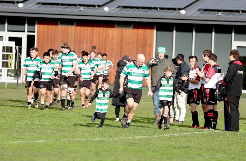 Prior to the match, he led the side onto the field with his children Eli, 6, and Noah, 9. PHOTO:...