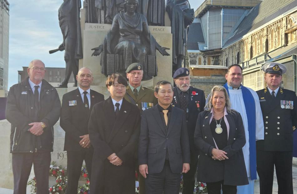 Participants pose for a group photo after the Korean War Veterans Commemoration Ceremony held in...