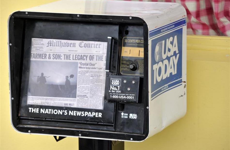 A newspaper dispenser outside the ''yellow diner''.