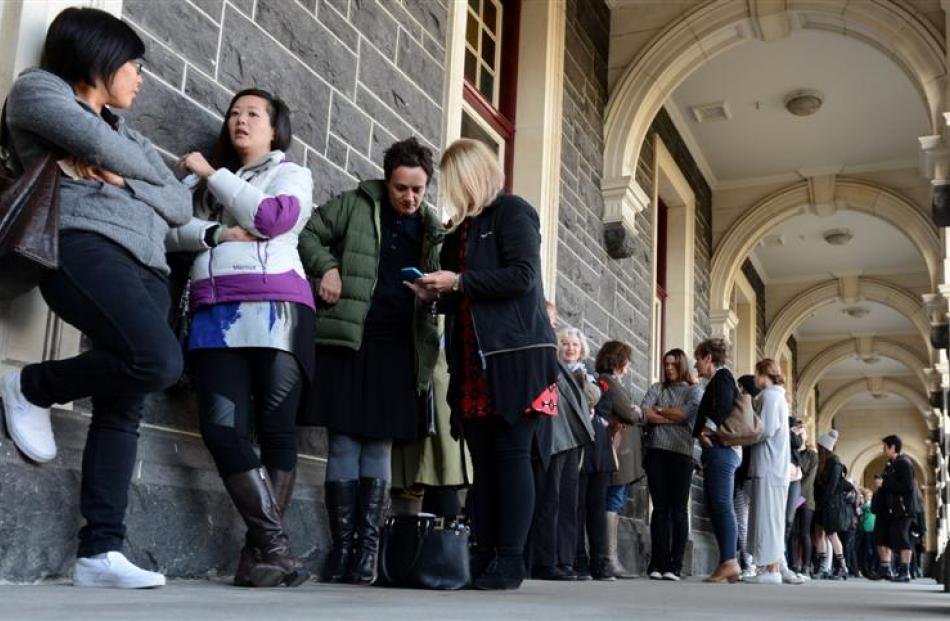 Shoppers wait in line outside the iD Designer Sale at Dunedin Railway Station on Saturday.