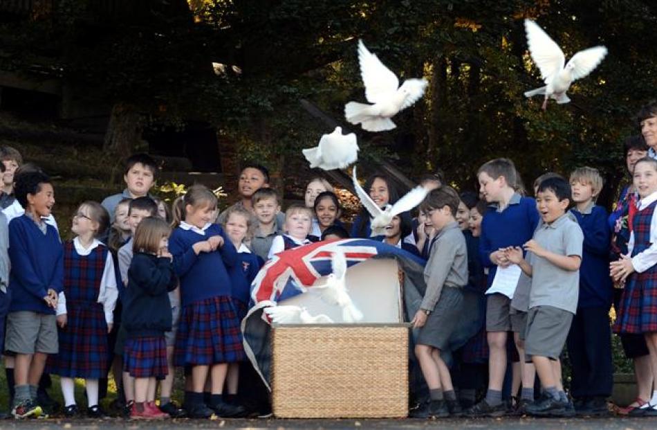 Sacred Heart School pupils release doves at their Anzac service yesterday. The service reminded...