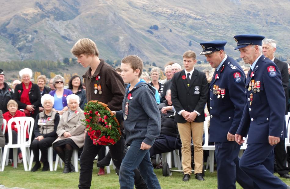 Nick (15) and Liam (10) Bates, wear the medals of their late father, Wanaka volunteer firefighter...