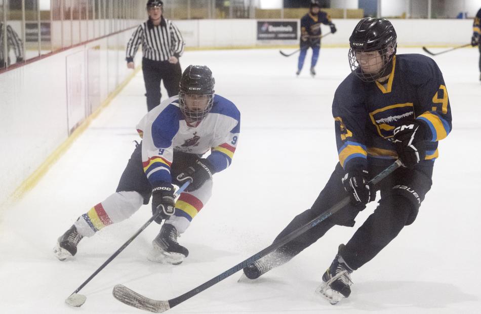 Ben Koh (John McGlashan) attempts to capture the puck from Brian Yang (Otago Boys’) during a...