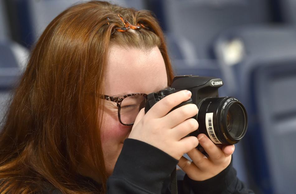 Otago Polytechnic student Rheah Pullar, 18, captures the action during the netball. PHOTO: PETER...