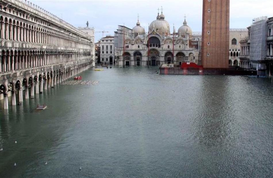 A view of a flooded St. Mark's Square, with St. Mark's Basilica in the background. Photo Luigi...