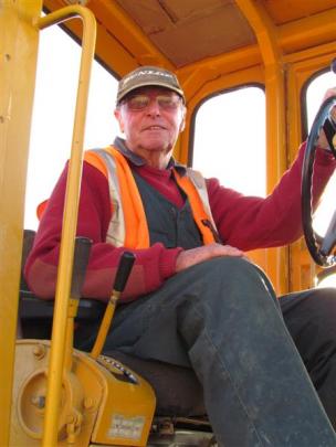 Project manager Bruce Wheeler helps out with grader.