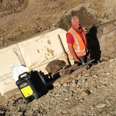 Volunteer Ben Gold works on a new culvert to take stormwater and drain the area above the road....