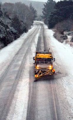 A snow plough works to reopen the Northern Motorway yesterday morning. PHOTO: GERARD O'BRIEN.