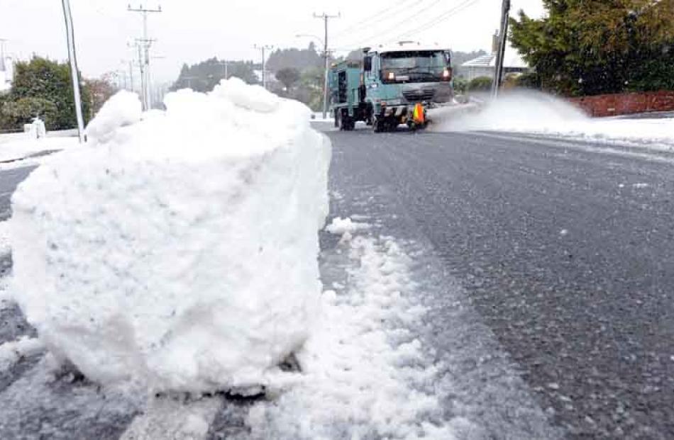 An isolated Snow ball sits pearched on the middle of Taieri Road after a Winter blast on monday....