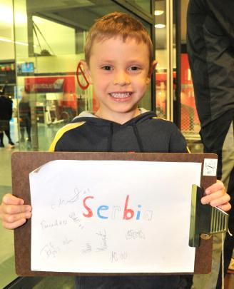 Blaike Fairley (5), of Mosgiel, shows off his autographs from members of the Serbian team